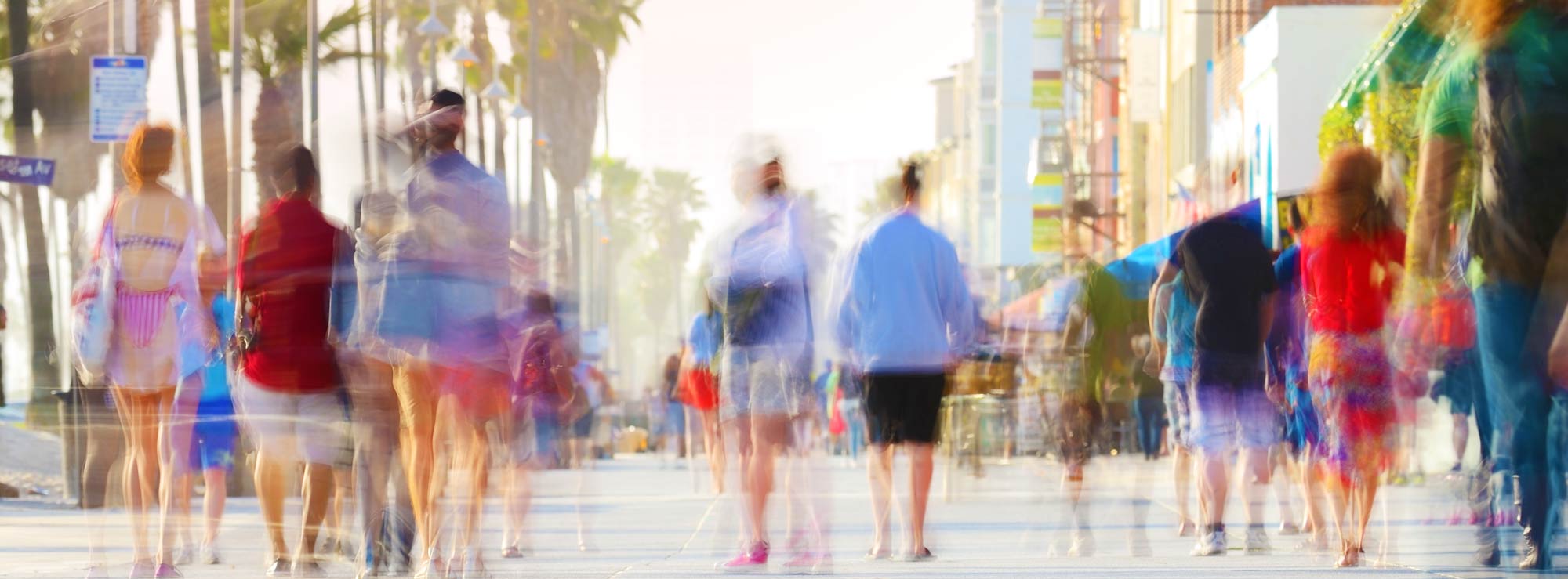 Colorful crowd walking along Venice Beach